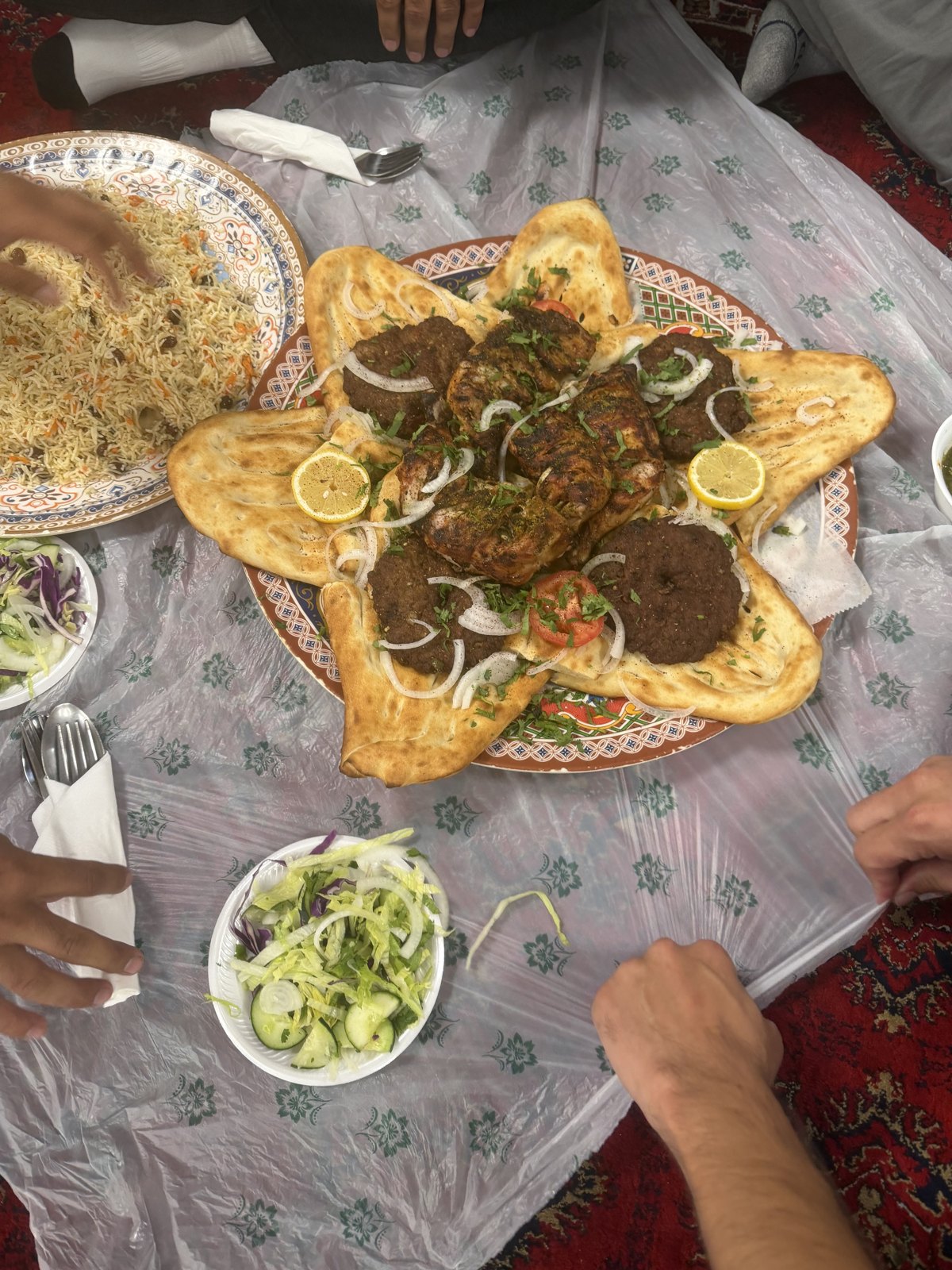 A large shared kabob and naan platter served family style at Afghan House