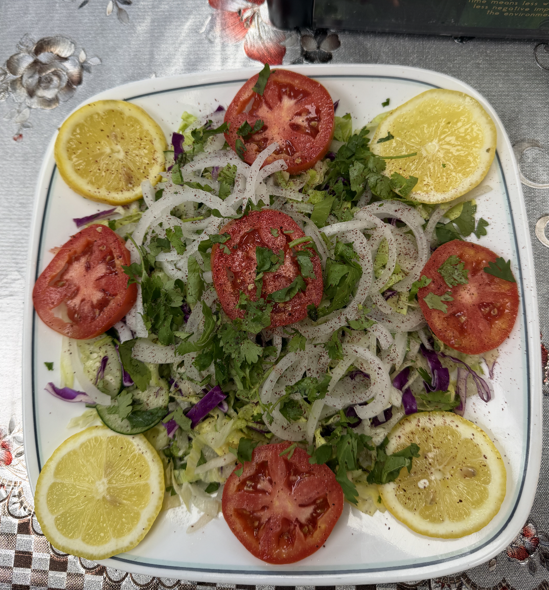 Fresh Afghan salad with tomato, onion, herbs and lemon at Afghan House