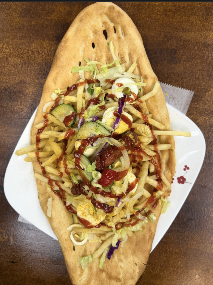 Afghan naan topped with fries, egg, salad and chutney at Afghan House