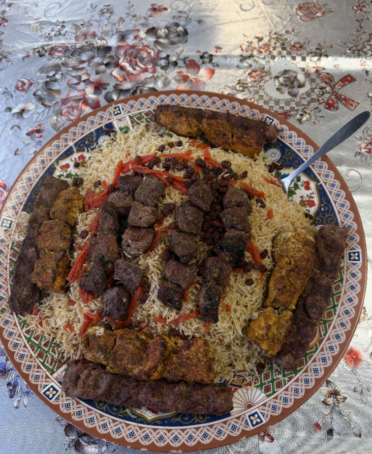 A generous Afghan platter of rice, kabobs, and tikka served family style at Afghan House